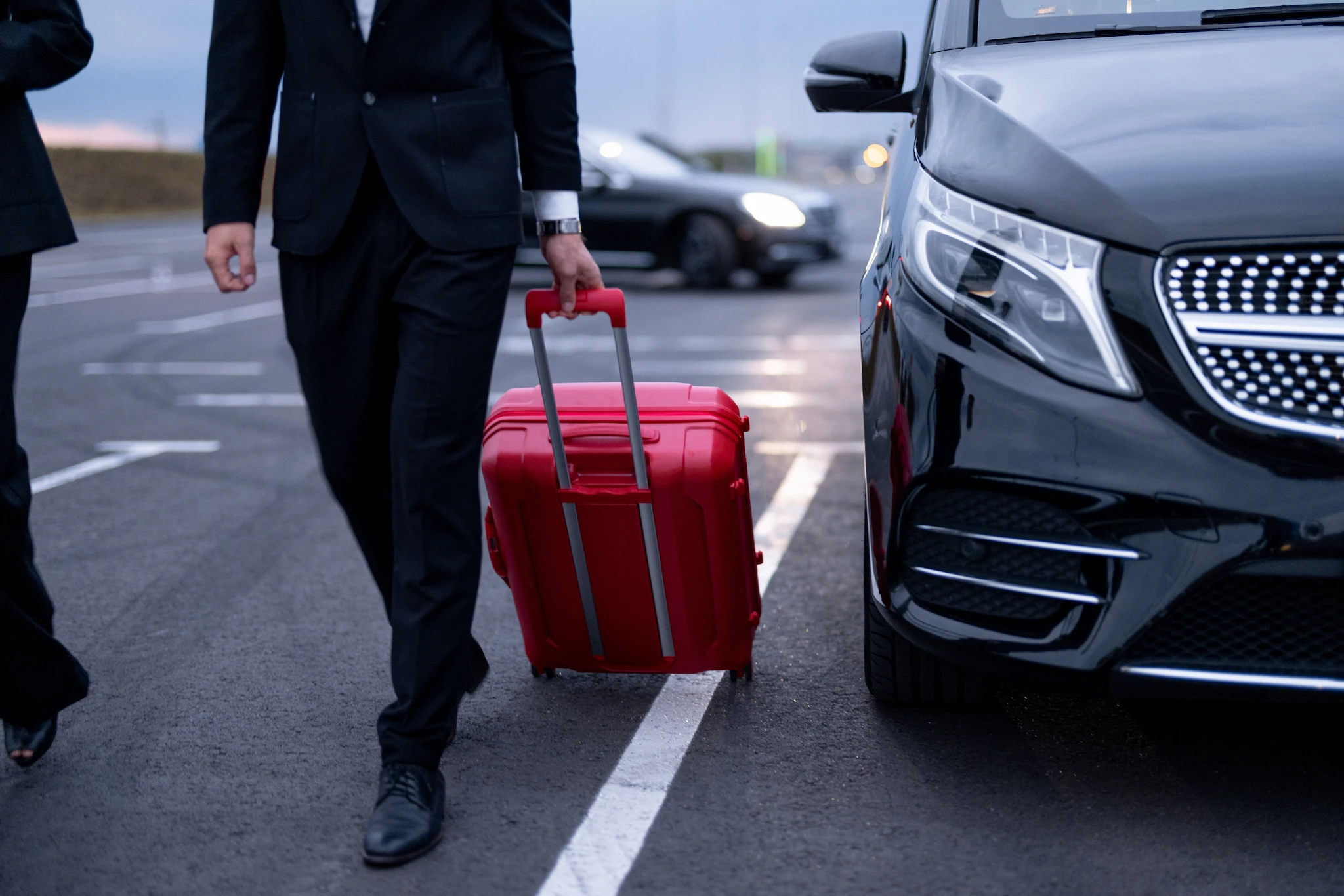 Private transfer vehicle at GYD Airport with a suitcase carrier.