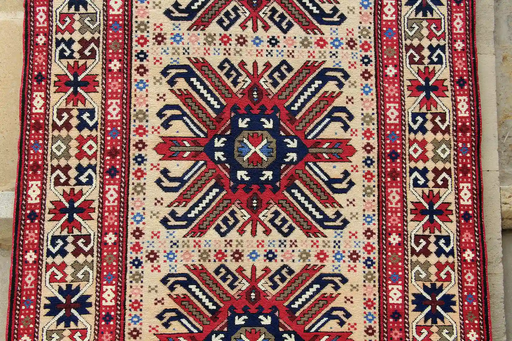 Flat-woven Azerbaijani Carpet Flat-woven Azeri carpet with red, white, and black ornaments.